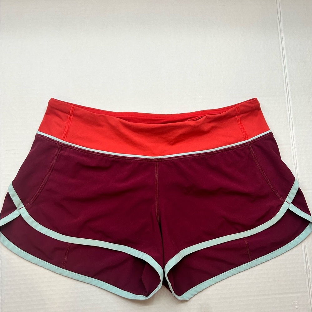 Orange, maroon, and teal lululemon speed up shorts